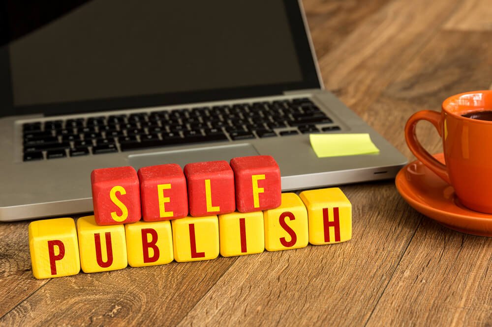 self publish blocks, laptop, and coffee