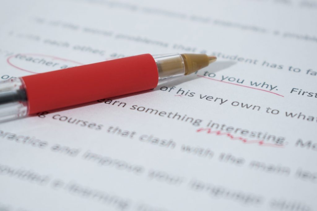 Red Pen on English Grammar Text Editing a manuscript