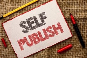 paper with self publish written and pencils